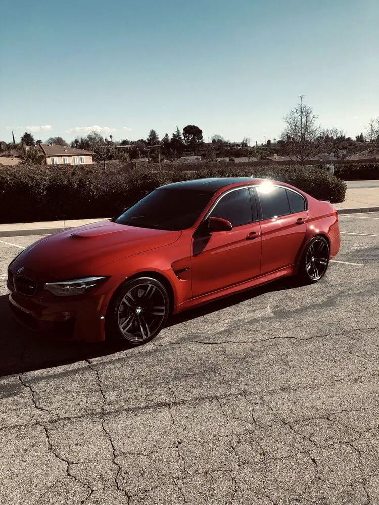 Red BMW M3 with dark window tint