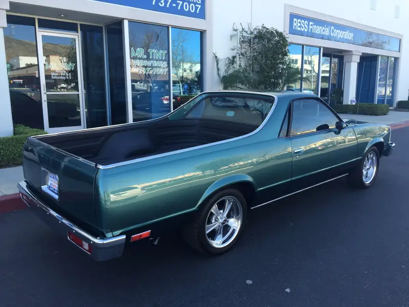 Classic teal Chevrolet El Camino outside the shop