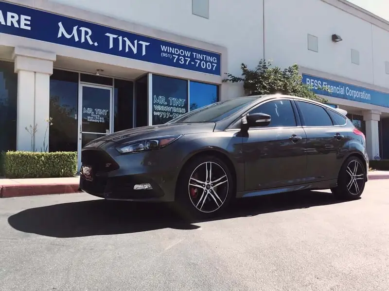 Gray Ford Focus hatchback outside the Mr. Tint storefront