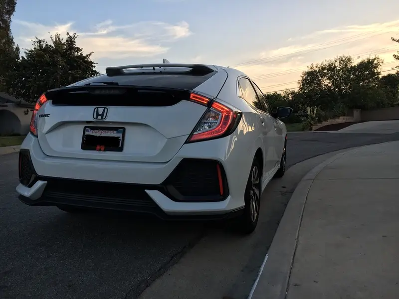 White Honda Civic hatchback with tinted rear glass